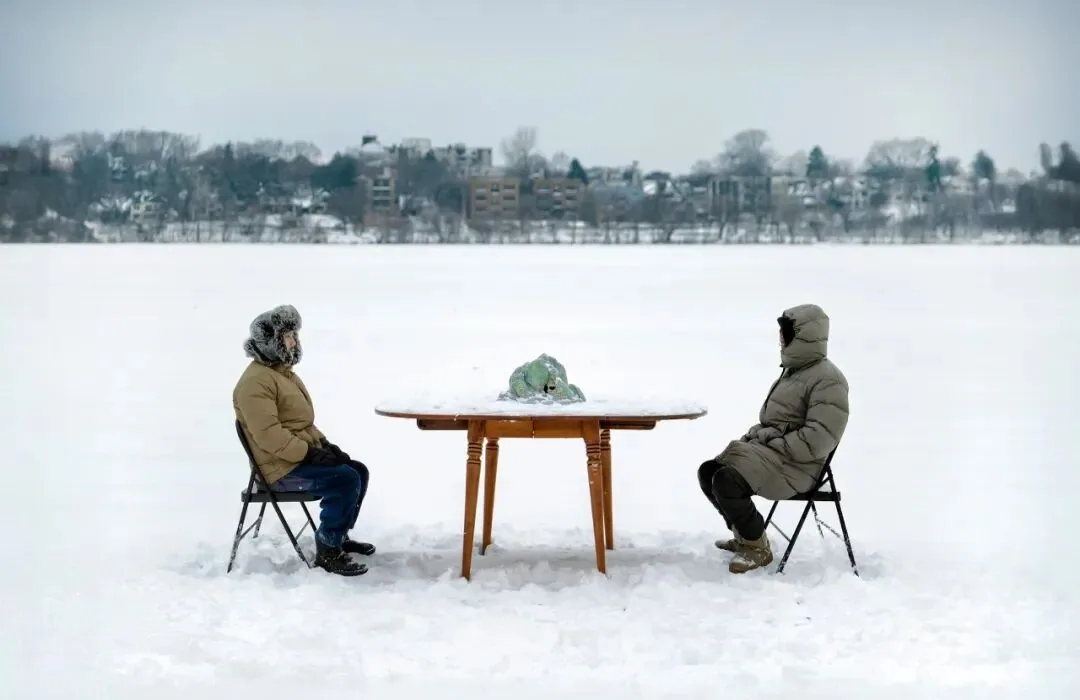 Youyang with a ceramic mountain on a frozen lake in Minneapolis.